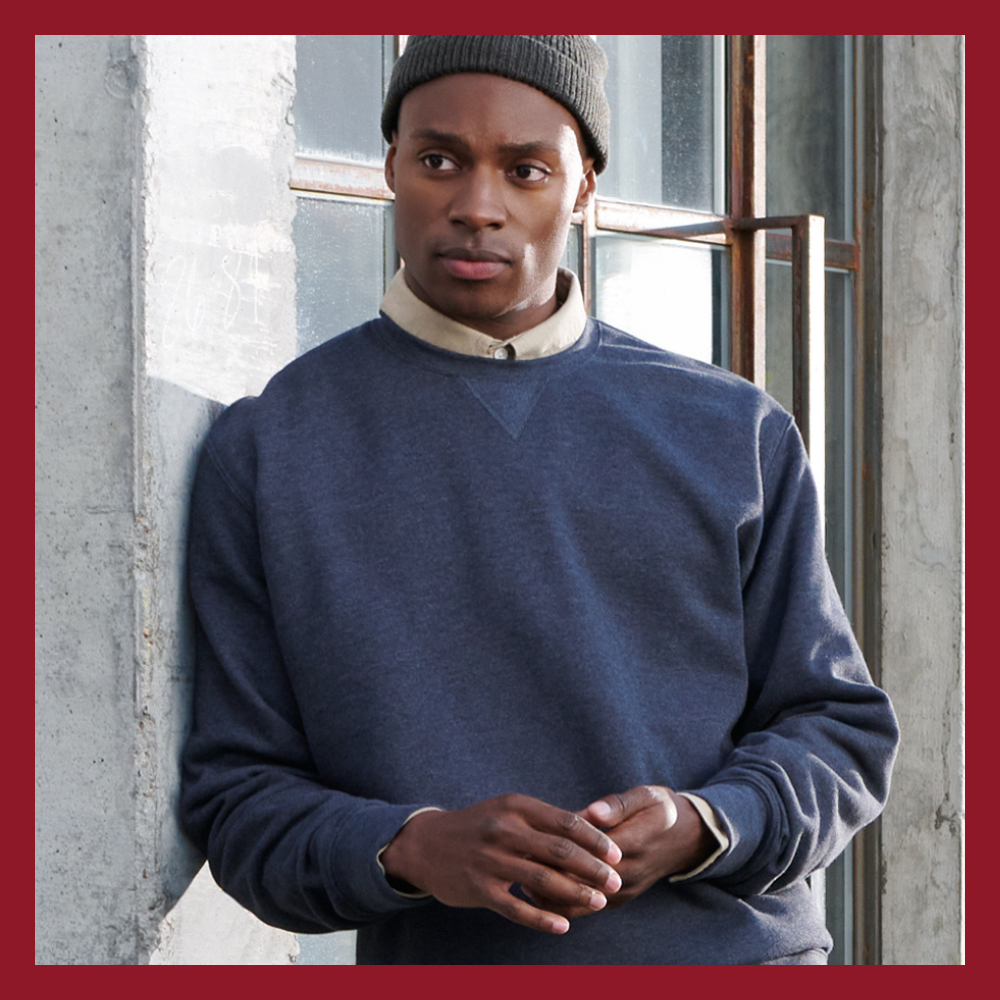 Male model wearing vintage blue sweatshirt with white collar shirt and sock hat.